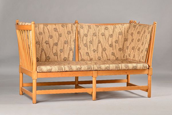 After Borge Mogensen; a beech framed spoke back sofa, 168cm wide x 87cm high. Illustrated.