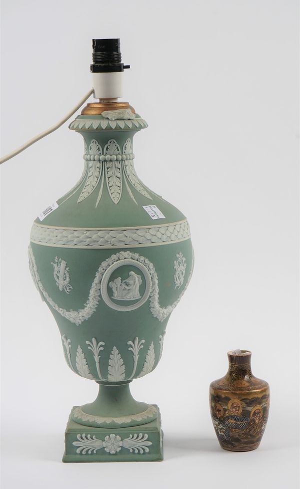 A Wedgwood green jasper vase, late 19th/20th century, the pear shaped body sprigged in white with panels of classical figures alternating with trophie