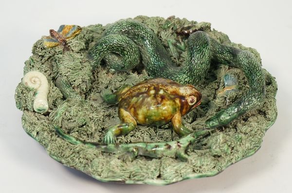 A Palissy style earthenware  plate, early 20th century, decorated with applied snake, frog, lizard and insects, stamped 'HOSE A CUNHA PORTUGAL' to rea