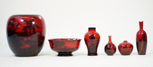 A Doulton flambe ware vase of ovoid form decorated with a windmill against a landscape, black printed marks, 23cm high and five further Doulton flambe