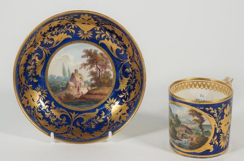 A Derby porcelain blue-ground coffee can and saucer, circa 1815, painted with named views, Near Buxton, Derbyshire, and Near Breadshall, Derbyshire, a