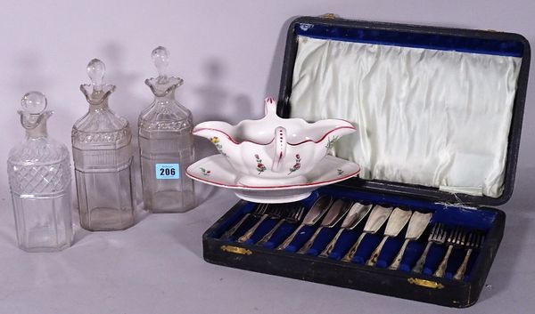 A group of three late 18th century glass decanters, a silver plated cased flatware and 'Luneville' ceramic sauce boat decorated with flowers, (5).  S4