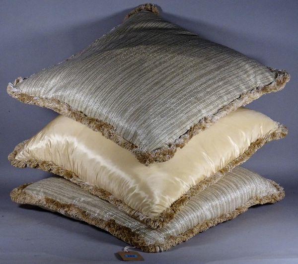 A group of three modern part silk cream and gold cushions, each 62cm wide. D2