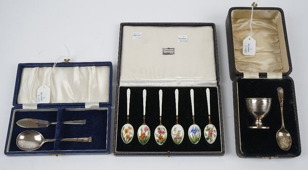 A set of six silver gilt and enamelled coffee spoons, the backs of the bowls decorated with differing flowers, Birmingham 1963, cased, a silver butter