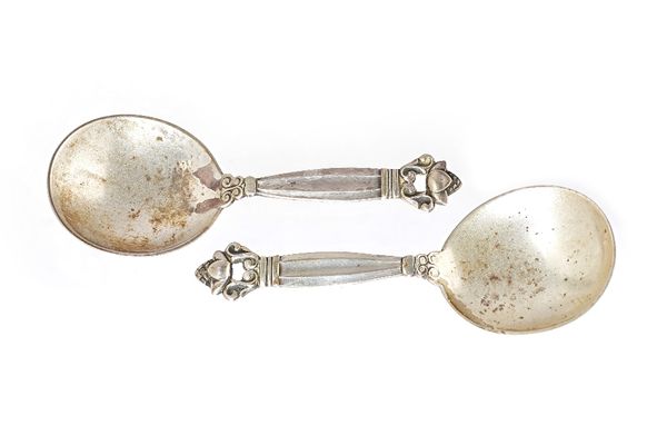 Two similar Georg Jensen silver caddy or preserve spoons, each having a cast and pierced finial to the handle, detailed 925S, import mark London 1925