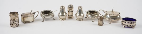 A group of silver condiments, comprising; two mustard pots, a pair of circular salts, each raised on three feet, Sheffield 1906, four pepperettes, ano