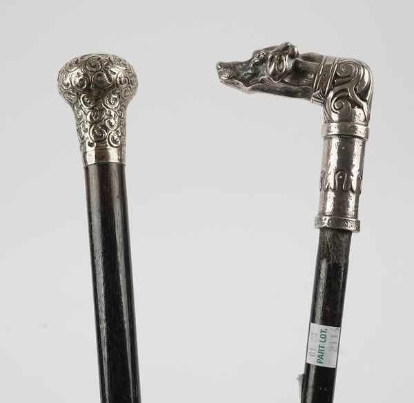 A silver topped ebonised walking cane, with scroll embossed decoration, the hallmark rubbed and another ebonised walking came, with an associated cast