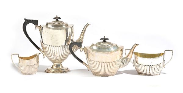 A silver four piece tea and coffee set, comprising; a teapot, a coffee pot, a twin handled sugar bowl and a milk jug, each piece of oval form, with pa