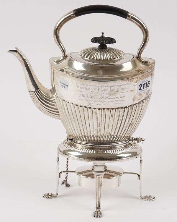 A silver spirit kettle, stand and burner, the kettle of oval form, with partly fluted decoration, presentation inscribed and engraved with a crest and