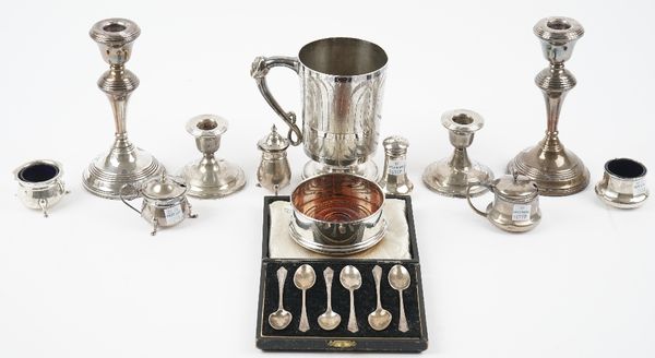 Silver and silver mounted wares, comprising; six coffee spoons with a case, two pairs of candlesticks, a bottle coaster, with a turned wooden base, Lo