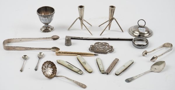 Silver and silver mounted wares, comprising; two pairs of sugar tongs, a sugar sifting spoon, a preserve spoon, two condiment spoons, an egg cup, a li