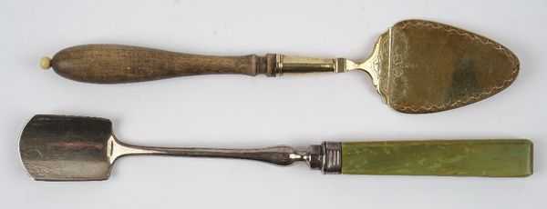 A George IV silver cheese scoop, with a green stained ivory handle, London 1827 and a gilt small serving slice, with engraved decoration, detailed IML