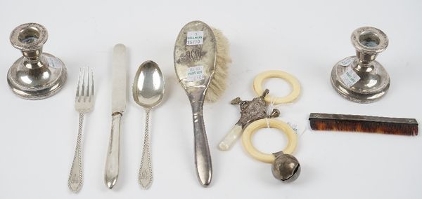 Silver and silver mounted wares, comprising; a three piece christening set, comprising; a knife, a fork and a spoon, London 1924, two rattles, a hairb