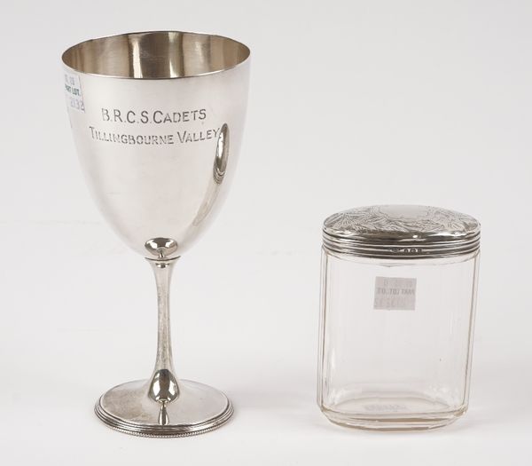 A silver trophy cup, presentation inscribed, raised on a circular foot, Sheffield 1896, height 16cm and a silver lidded, faceted oval glass toilet jar