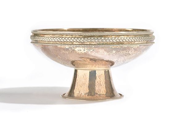 A silver footed bowl, of circular form, the rim decorated with a platted band within ropetwist borders, raised on a flared foot, having a ropetwist bo