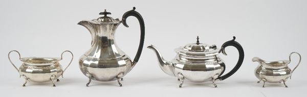 A silver four piece tea set, comprising; a teapot, a hot water jug, a twin handled sugar bowl and a milk jug, each piece of panelled oval form, raised