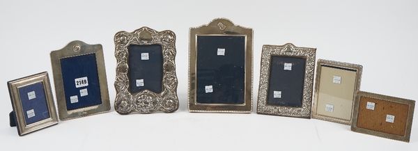 Seven silver mounted rectangular and shaped rectangular photograph frames, in a variety of designs, (7).