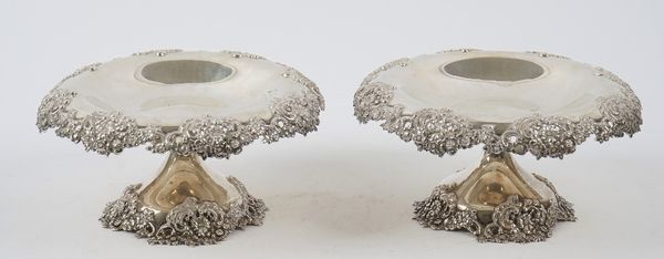 A pair of Tiffany & Co sterling silver pedestal comports each with floral, foliate and scroll pierced decoration to the shaped border and raised on a