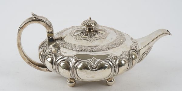 A George IV silver teapot, of squat shaped circular form, the body decorated with lobed panels within a floral and scroll moulded rim, with a foliate