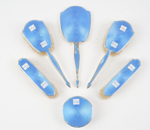 A lady's silver and blue enamelled five piece part dressing set, comprising; a pair of clothes brushes, a hand mirror, a pair of hairbrushes and a cir