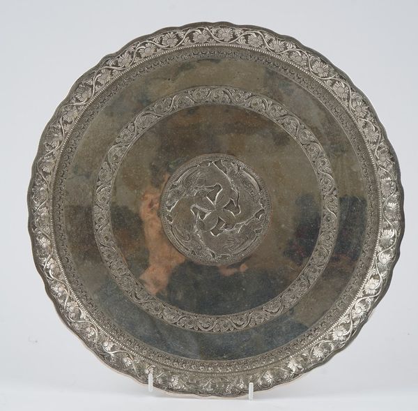 An Asian shaped circular salver, the centre decorated with four entwined birds, otherwise decorated with a scrolled band within a shaped floral border