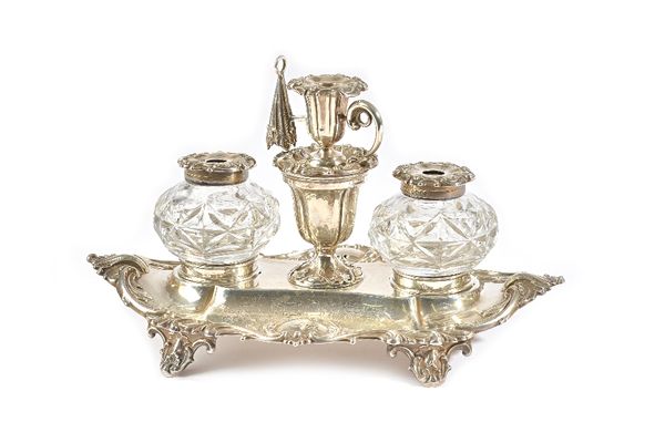 A Victorian silver twin bottle inkstand, of shaped oval form, decorated with scrolling border, raised on four feet, presentation inscribed, fitted wit