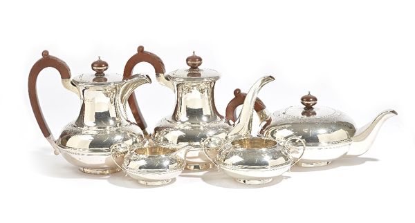 A silver five piece tea and coffee set, comprising; a teapot, a hot water jug, a twin handled sugar bowl and a milk jug, London 1934 and a coffee pot,