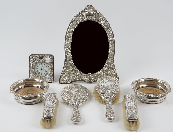 A Victorian silver mounted four piece part dressing set, comprising; a hand mirror, a hairbrush and two clothes brushes, also a silver mounted oval st