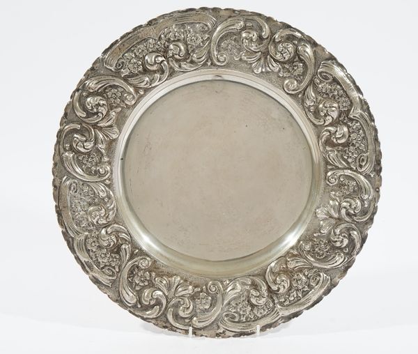 A shaped circular large dish, the wide border with floral, foliate and scroll embossed decoration, detailed 800, diameter 38cm, weight 838 gms. Illust