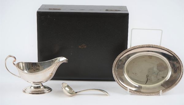 A Mappin & Webb silver sauceboat, with a sauce ladle and an oval stand, decorated with gadrooned rims, combined weight 351 gms, with a case.