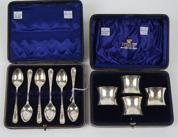 A set of four silver napkin rings, numbered 1 to 4, London 1903, with a case and a set of six silver coffee spoons, Sheffield 1903, with a case, combi