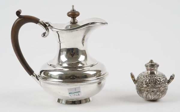 A silver hot water jug, with wooden fittings, raised on a circular foot, Birmingham 1922, gross weight 282 gms and a Middle Eastern twin handled vesse