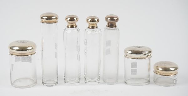 A group of seven European glass toilet bottles and jars, the detachable covers engraved with crown motifs, (7).