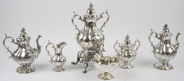 An American plated six piece tea and coffee set, comprising; a twin handled lidded urn, with a stand, (the spirit burner lacking), a teapot, a coffee