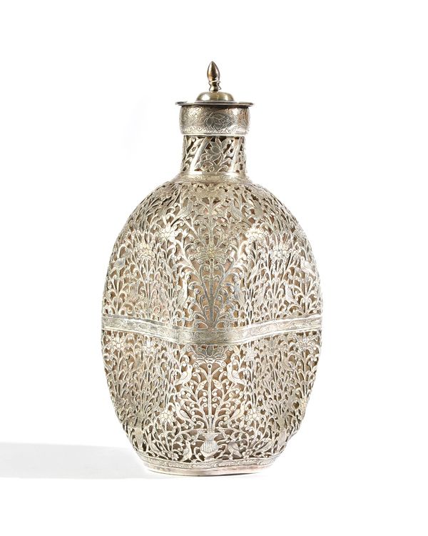 A glass dimpled decanter, with an applied Chinese casing, engraved and pierced with birds amidst shrubs, with a pull-off stopper, height 22.5cm. Illus