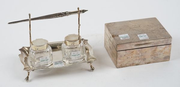 A silver twin bottle pen and inkstand, the stand of shaped rectangular form, raised on four ball and claw feet, Birmingham 1901, length 14cm, with two