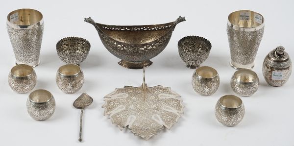 A group of Persian and Asian wares, comprising; a twin handled boat shaped dish, a leaf shaped dish, a pair of beakers, a pair of salt frames, six nap