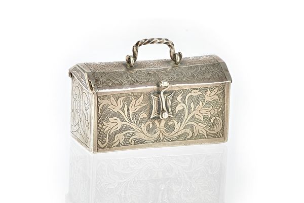 A miniature domed chest, with foliate and scroll engraved decoration, the top with a ropetwist handle, the front with a hook catch, apparently unmarke