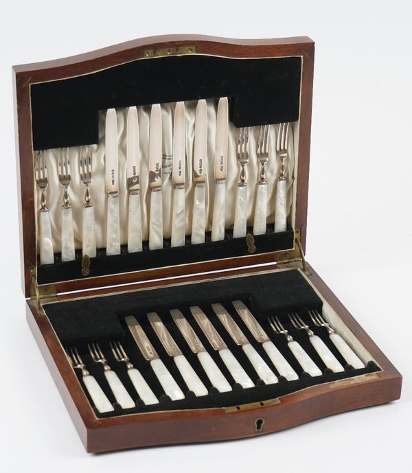 A set of twelve silver and mother-of-pearl dessert or fruit knives and forks, having silver blades and prongs and with mother-of-pearl handles, Sheffi