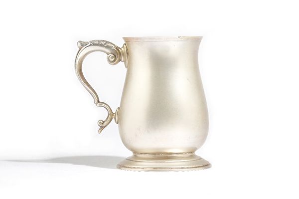 A silver mug, of baluster form, with a scrolling handle, in an 18th century style, Birmingham 1971, height 12.8cm, weight 340 gms. Illustrated.