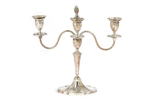 A silver three light table candelabra, the central stem raised on a shaped oval base, the detachable top section with reeded arms, height 29.5cm, Birm