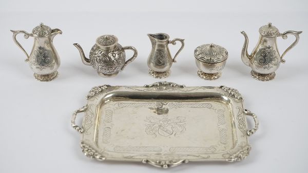 A miniature tea/coffee set, comprising; a shaped rectangular twin handled tray, a coffee pot, a hot water jug, a sugar bowl and cover and a milk jug,