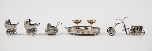 A group of mostly silver miniatures, comprising, an oval twin handled gallery tray, having an oak base, Birmingham 1907, two champagne coupes, Birming