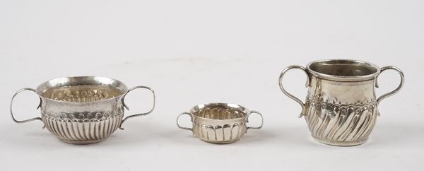 A silver twin handled miniature porringer, with semi-fluted decoration, maker's mark only LL and two further miniature twin handled porringers, combin