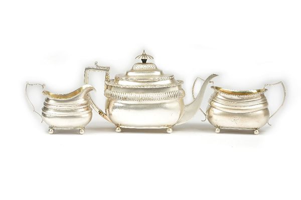 A silver composite three piece tea set, comprising; a teapot, London 1807, a twin handled sugar bowl, London 1815 and a milk jug, London 1814, three d