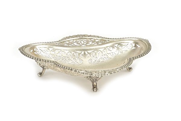 A silver dish, of trefoil shaped form, having scroll pierced decoration within a gadrooned rim, with scallop motifs, raised on three scroll feet, Shef