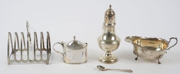 Silver, comprising; a Victorian oval mustard pot, crest engraved, London 1880, with a blue glass liner, a Victorian mustard spoon, London 1878, a suga