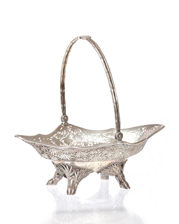 A Chinese silver basket, of shaped oval form, the body with pierced and engraved bamboo decoration, raised on four simulated bamboo feet and with a si