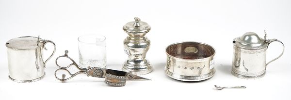 Silver, comprising; a cylindrical mustard pot, with a domed hinged lid, decorated with engraved bands, London 1911, a pepper mill, London 1903, a bott