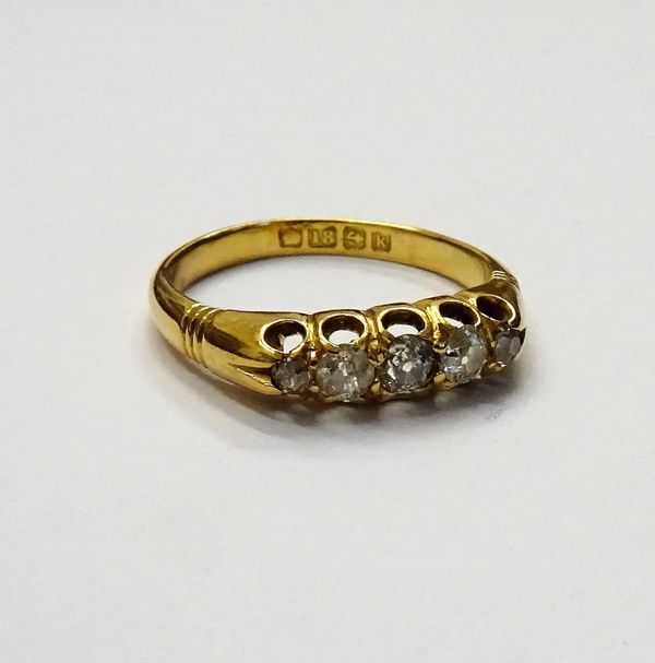 An 18ct gold and diamond set five stone ring, mounted with a row of cushion shaped diamonds graduating in size to the centre stone, Birmingham 1909, r